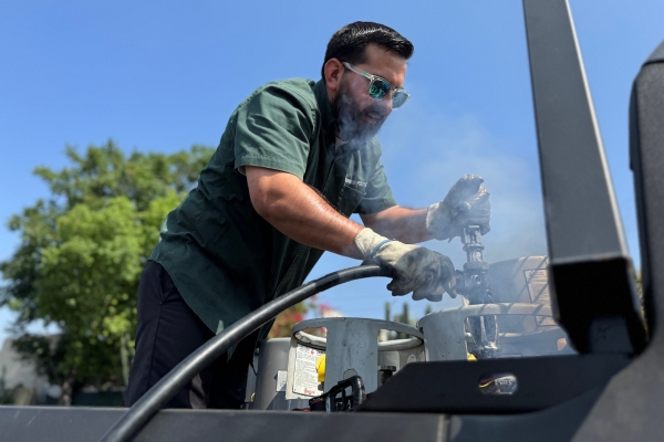 Ted Johnson Propane staff refilling propane tank