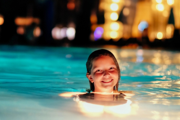 young girl swimming at night