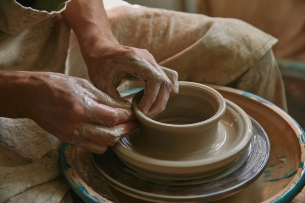 male craftsman working on wheel pottery