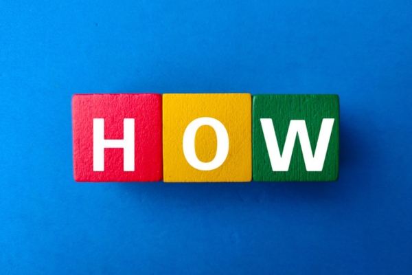 HOW spelled using colorful wooden letter cubes depicting How Businesses Can Transition to Propane Vehicles