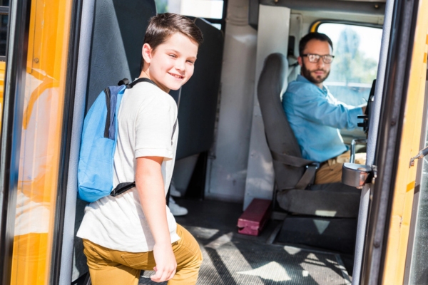 school bus driver and student smiling