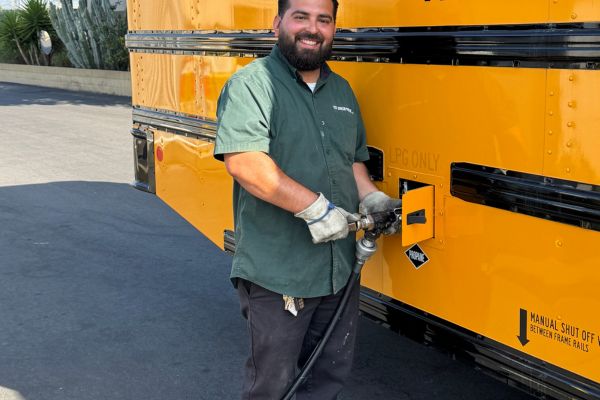 Ted Johnson Propane staff refueling propane-powered school bus