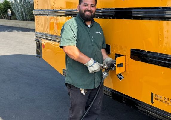 Ted Johnson Propane staff refueling propane-powered school bus