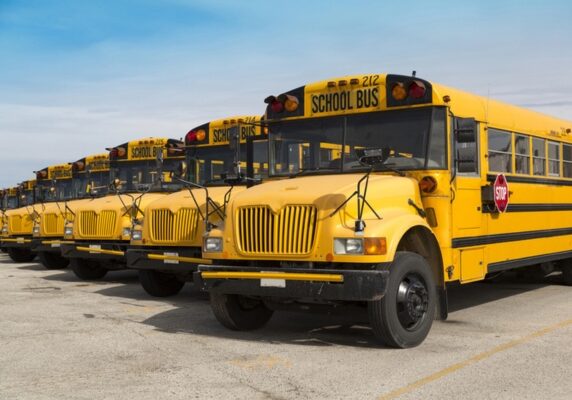 school bus fleet parked beside each other